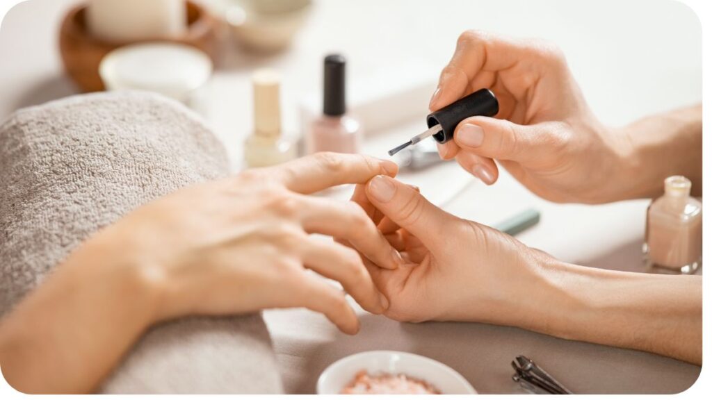 a person getting their nails done by a manicurist