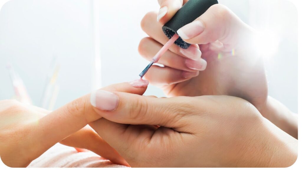 a person getting their nails done at a nail salon