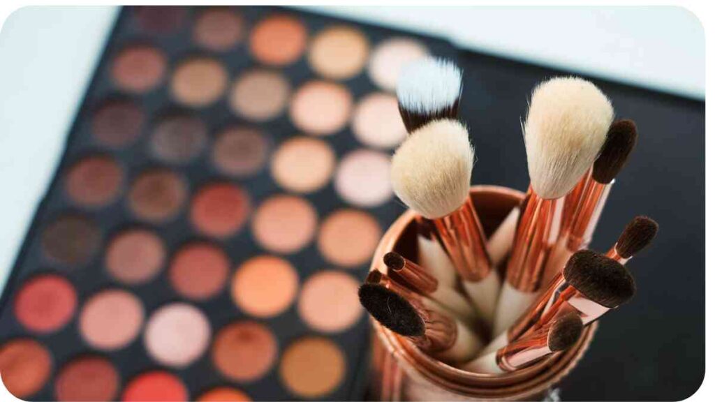 makeup brushes in a vase on a table