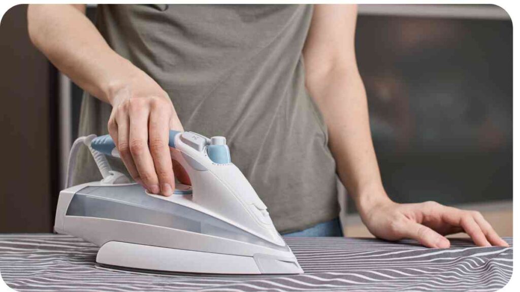 a person is ironing on a table with an iron